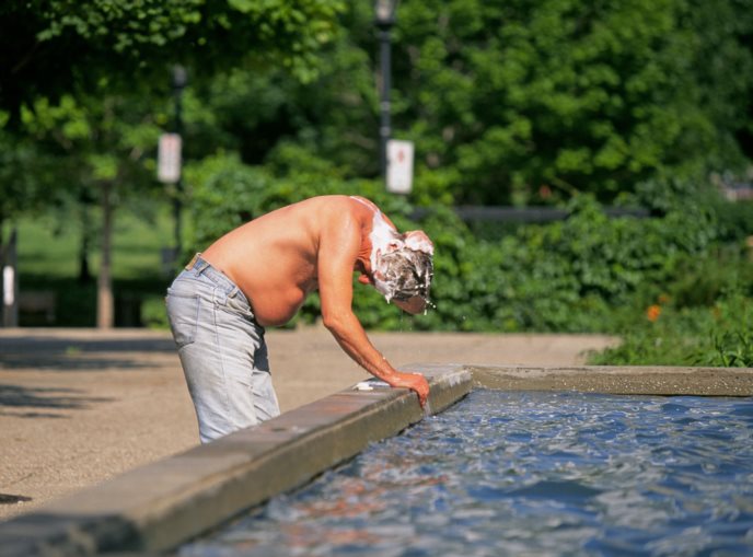 Homeless Man Bathing in Public